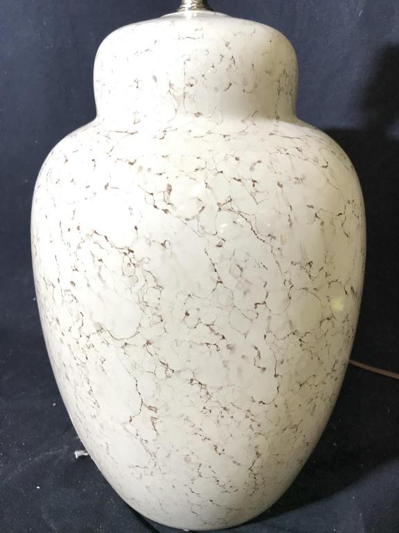 Marbled Patterned Detail Porcelain Lamp: Lamp is porcelain. Piece is cream toned and contains marbled patterned detail. Lamp includes finial 26 inches tall 9 inches wide. Table lamp, porcelain lamp. home lighting and accessories, home decor 