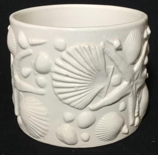 White Italian Ceramic decorative Seashell vessel: White ceramic jar vessel measuring approximately 6 inches tall and 6.5 inches diameter. Dimensional seashells and starfish on outer surface. Slight chips. Bottom reads made in Italy, for b. Altman and