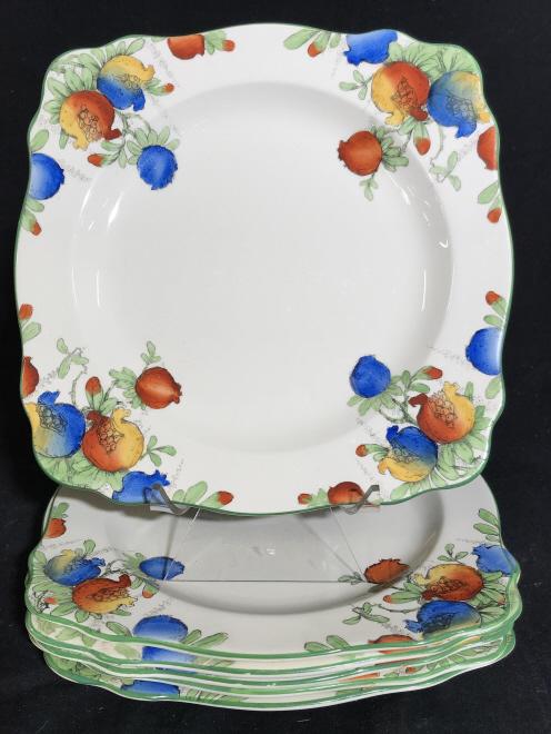Set 6 CROWN DUCAL Fine China Art Deco Plates: Each marked on underside for CROWN DUCAL WARE, ENGLAND A-1209. Serving plates feature square shape and multi-color pomegranate motifs with hand-colored detailing. Each measures approx 8.35 inches squa