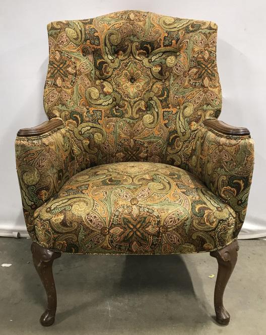 Vintage Curved Back Wing Chair: Vintage Curved Back Wing Chair With carved arm rests and feet, and earth toned Paisley Upholstered Fabric, chips and scratches to wood and wear to fabric in areas, measures approximately 43 inches tal