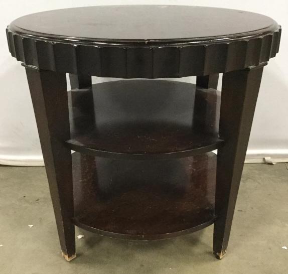 Vintage Round Carved Wooden Table: Table is wooden. Piece appears to be vintage. Piece is chocolate toned. Table has 2 shelves underneath table top. Piece measures approx 28 inches tall 30 inches wide. Comes some scratches and wear. ta