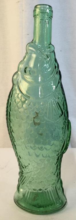 Green Toned Art Glass Fish Bottle: Bottle is green toned and glass. Piece resembles a fish. Bottle measures approx 13 inches tall 4.5 inches wide. bottle, vessel, collectibel art glass 6.