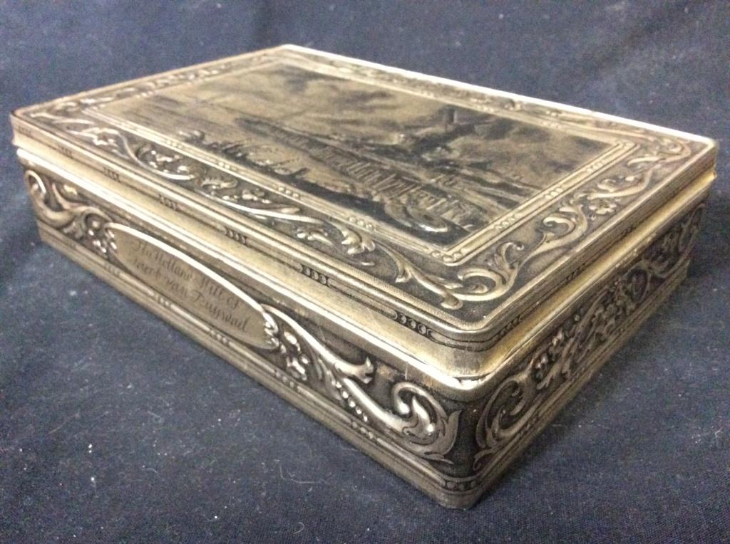 Silver Toned Metal Keepsake Box: Keepsake box is metal and silver toned. Piece has beveled depiction of lake, boats, and windmill. Piece measures approx 9 inches long 6 inches deep 2.5 inches tall. keepsake trinket box, dresser box,