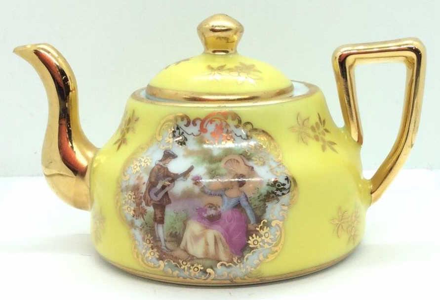 BARDET LIMOGE Decorative 3 in Teapot, France: Yellow tone with gold toned floral design and trim, romantic Victorian scene in garden, underside reads Bardet Limoge France, measures app 3 in by 4 1/2 in by 3 in, Some minor wear to paint. Collectib
