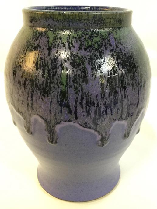 Purple Toned Ceramic Vase: Vase appears to possibly be handmade. Piece has a light indigo tone. Vase, ceramic vase, pottery, ceramic pottery, purple vase. Underside of piece has marking. Measures approx 7 inches tall 5 inches w