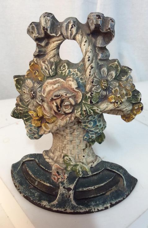 Vintage iron floral basket doorstop: Vintage iron Doorstop in the shape of basket containing flowers. Approximately 7 inches tall. Paint is chipped. Green toned. Flower basket, iron, iron Doorstop, vintage doorstop, decor, home, vintage 