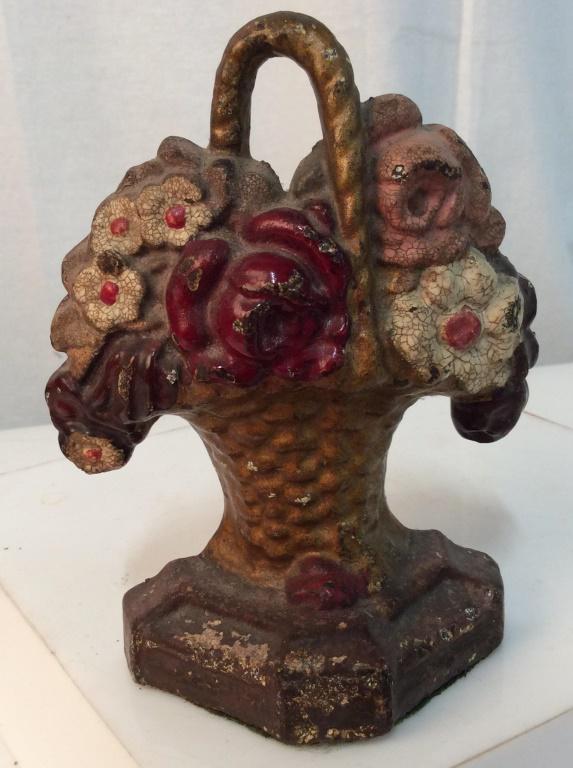 Vintage iron floral doorstop: Warm and red tones. Approximately 6.5 inches tall. Paint is chipping. Doorstop, vintage, vintage decor, decorative arts, vintage items, vintage collectible, collectible, collectible item, collectibles