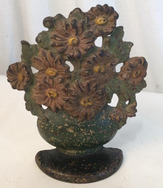 Vintage iron flower basket doorstop: Vintage iron doorstop in the shape of a flower basket and flowers. Measures approximately 7 inches tall. Paint is worn. Vintage, vintage collectible, collectible, collectible item, collectible doorsto
