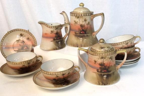 Lot 13 Vintage Japanese Porcelain Tea Accessories: Lot of 13 tea accessories. Ceramic porcelain. Bottom of teapot reads Hand Painted Made in Japan. Teapot is approximately 6 inches tall. Scene depicts a swan in a lake in front of a house at sunset. Lo