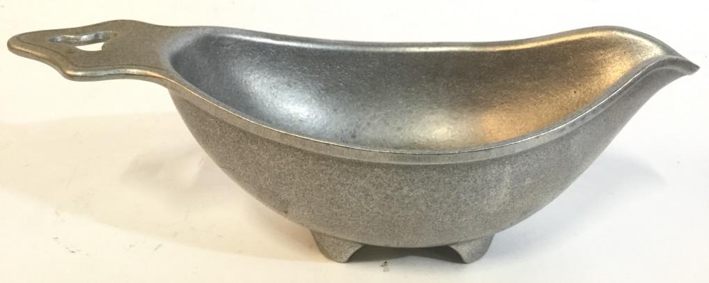 Silver Toned Pewter Gravy Boat: Gravy boat appears to be pewter. Underside is marked WILTON COLOMBIA PA. Piece measures approx 10 inches long 4.5 inches wide 3 inches tall. gravy boat, tableware, decorative arts and accessories 6
