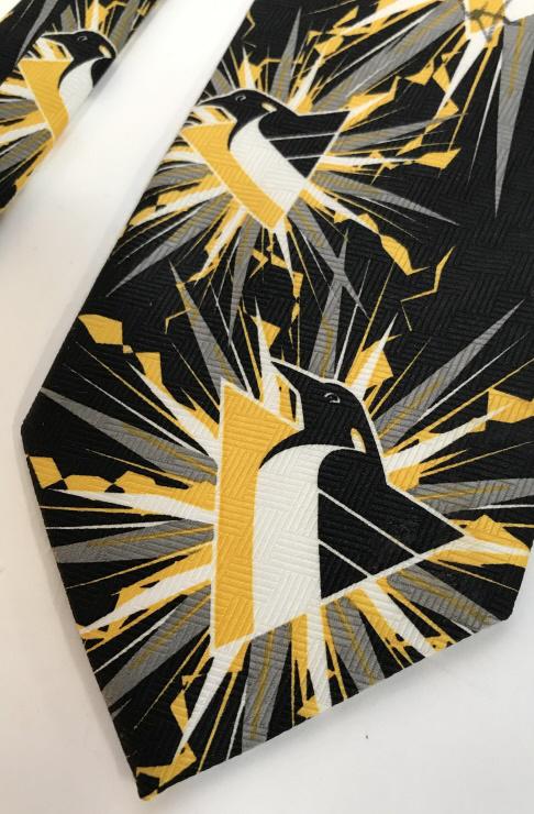Pittsburgh Penguins NHL Fashion Necktie: Penguins Team Logo on tie. 100 % polyester. Licensed by NHL from Designer Ralph Marlin. Label on fabric. Appears never work, does have mark on penguin. National Hockey League Licensed Necktie, Pittsbu