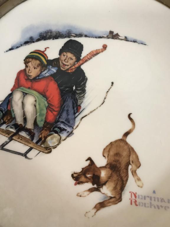 Vintage Norman Rockwell Gorham Fine China Plate: Fine China decorative wall plate measuring approximately 13 inches in diameter. Front features two kids on a sled with a dog following. Backside reads As America’s best loved artist Norman Rockwell 