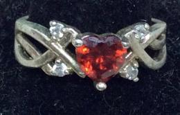 Heart Shaped Mandarin Rhinestone Ring: Vintage ring, pot metal, 4 pavé clear rhinestones. Center stone the color of mandarin garnet, Clear, sparkly, faceted, heart shape. Metal has vintage wear. Size 6.5 - 7 . Garnet Color Ring, Heart Rhi