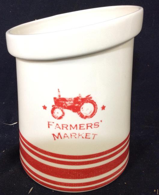 M. CHAD BARRETT Porcelain Vessel: Underside of piece is marked M. CHAD BARRETT. Vessel has image of tractor and reads FARMERS MARKET underneath. Piece has horizontal red toned stripes. Piece measures approx 8 inches tall 6.5 inches wi