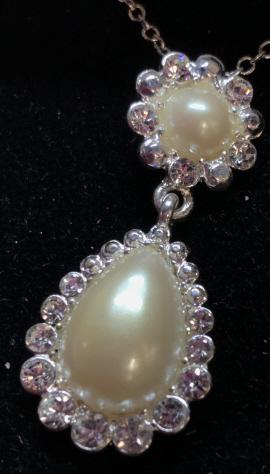 Liz Claiborne Boxed Jewelry Gift Set: Pierced Stud Earrings, pearl style cabochon with surrounding clear rhinestones. Silver toned metal. Matching necklace, dangle pendant. Necklace not measured, not removed from packaging. Costume Jewelr