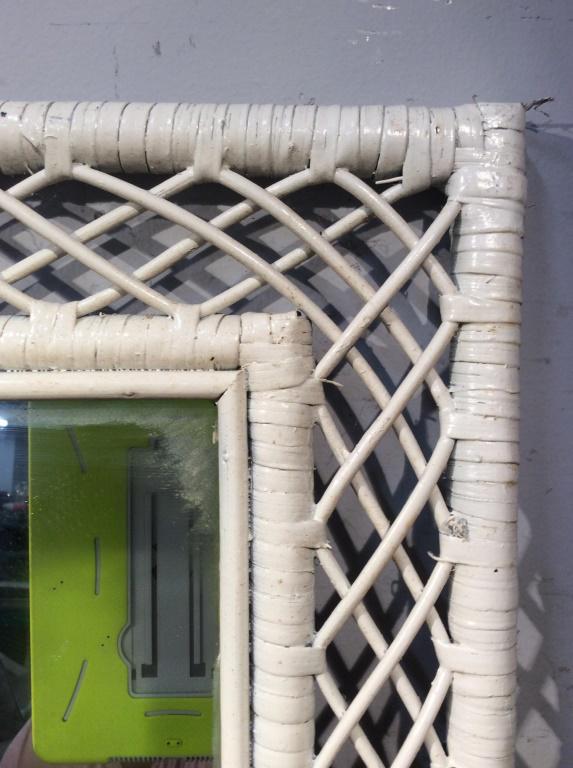White Toned Wicker Frame Mirror: Mirror frame is white toned. Piece contains woven wicker elements. Piece measures approx 30 inches tall 24 inches wide. mirror, wall hanging, vanity mirror, home accent and decor, 6