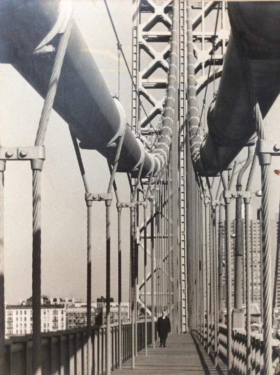 D PERLMAN Signed Framed Photographic Print: Signature reads D PERLMAN. Piece depicts a man walking across a bridge. Piece measures approx 21 inches tall 17 inches wide. fine art, industrial art, photographic print 6