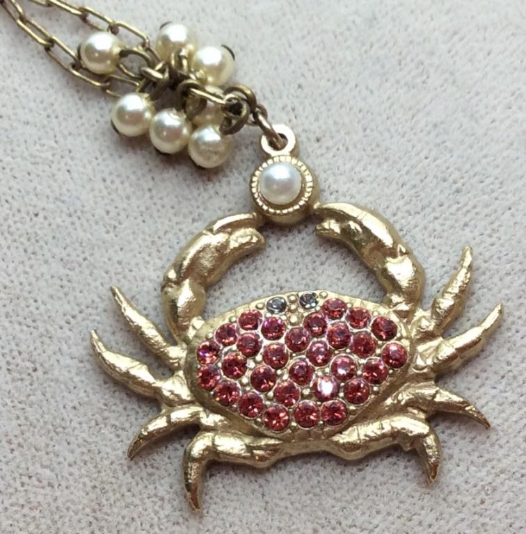 Catherine POPESCO Crystal Encrusted Crab Necklace: End Tassel marked for Catherine POPESCO, France. Crab pendant with red Swarovski crystals and pearl style details. Gold tone chain. Measures approx 18 inches fully extended. Estate jewelry, vintage je