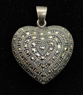 Vintage Sterling And Marcasite Heart Pendant: Vintage Sterling And Marcasite Heart Pendant, marked 925 on reverse of heart and on bail, 1.75 inches tall x 1.25 inches wide x 5/8th inches deep. No condition issues noted. Ladies Silver Marcasite Pe
