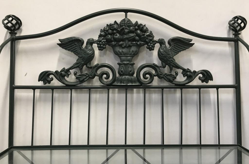 Vintage Metal Baker’s Rack W Bird&Floral Pediment: Vintage green tone metal, possibly wrought iron, baker’s rack with glass shelves. 4 shelves total. Floral details throughout, with bird and floral basket pediment top. Measures approx 74 inches in h