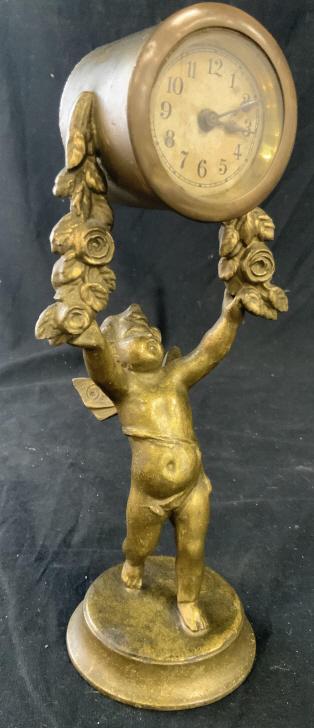 French Antique Cherub Clock, Gilded Metal: Marked on base for Paris, additional writing illegible, clock is held high by winged angel Cherub Figural and cascading floral swags, antique clock, French antique collectible clock, property of Westp