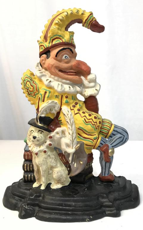 Cast Iron Punch & Judy Doorstop: Cast Iron Punch & Judy Painted Doorstop depicting Punch sitting on a pile of books with dog sitting At his feet, no condition issues noted, measures approximately 12 inches tall x 8.5 inches wide x 3.
