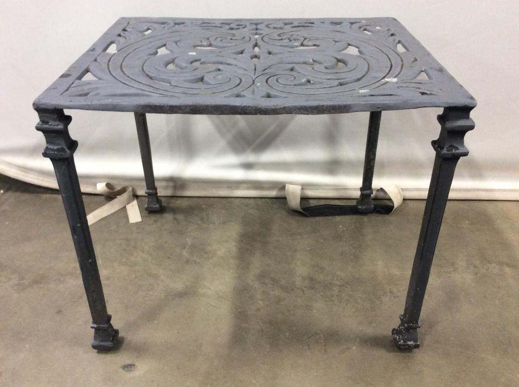 Slate toned Outdoor Metal Side Table: Side table is slate toned. table top contains pierce c scroll detail. Table has 4 legs. Outdoor table, outdoor metal table, metal side table. Measures approx 16 inches tall and deep 20 inches wide. Pi