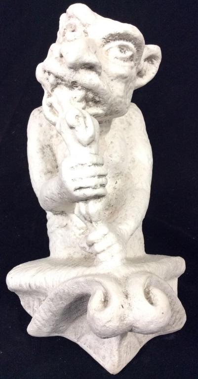 White Toned Plaster Gargoyle Sculpture: Gargoyle Sculpture is white toned. Piece appears to be plaster. Appears to depict a gargoyle eating. Piece measures approximately 10 inches tall 6 inches wide. Piece has chip. gargoyle, statue, archit