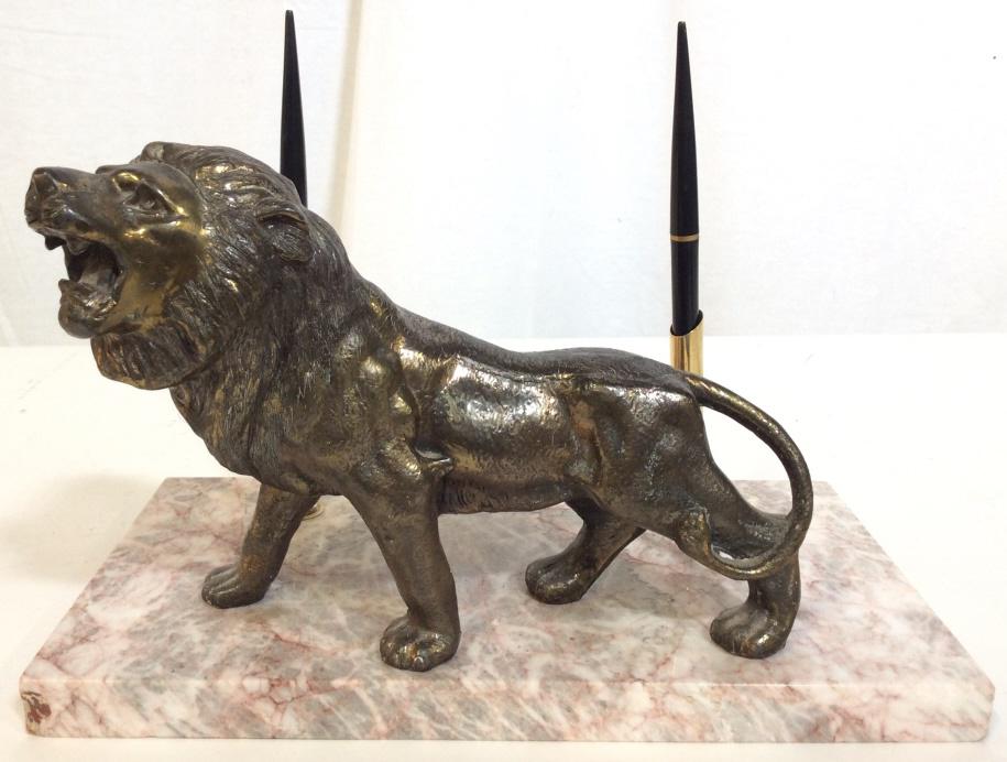 Vintage Marble & Metal Pen Holder: Pen holder has base which is possibly marble, Possibly stone. Lion Figural appears to Possibly be bronze, possibly brass. Piece holds 2 pens. Piece measures approx 12 inches long 8 inches tall 6.5 inc