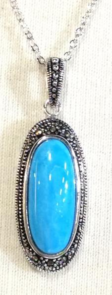 Turquoise & Marcasite Pendant Necklace: Center turquoise oblong stone, bordered by intricate marcasite design set in silver tone metal. Metal has brilliance, no tarnish. Chain is adjustable, 16 in. - 20 in. Turquoise is authentic. Lobster c