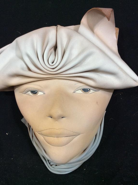 Vintage Gibson Signed Leather Decorative Mask: Artist signed hand crafted leather mask. Decorative wall mask of a woman. Appears to be hand painted. Signed Gibson on back. Discoloration. Measures approximately 9 inches. Mask, decorative mask, wall