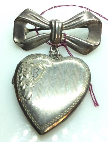 Sterling Silver Heart Locket Brooch, Vintage c.: 1940. Marked STERLING on back of heart. Bow Pin with dangle heart. Heart etched crest with Monogramed letter ‘B’ in crest. two windows for pictures, Piece acquired through closing antique store in
