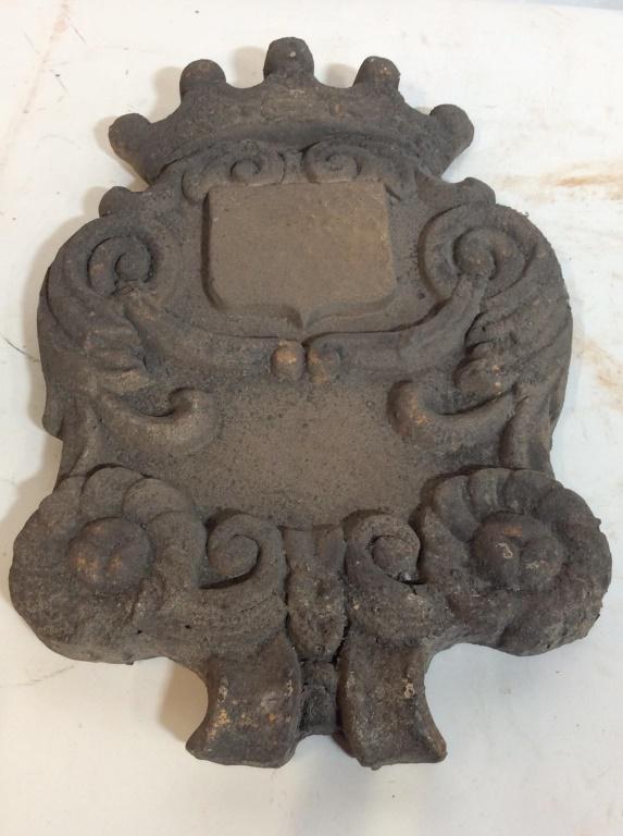 Stone Composite Wall Decorative Piece: Possibly stone plaster. Measures approximately 16 inches long. Front shows a crown, scrolls, and flowers. Center piece plaque for a name. Appears to be casted. Stone, Stone plaster, wall decor, outdoo