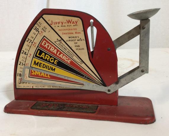 Vintage Farm Master Jiffy-Way Egg Scale: Vintage jiffy-way Labeled egg scale. Made from metal. Appears to have been repaired where egg is placed. Farm Master sticker on base. Measures approximately 8 inches long and 6 inches tall. Farm, farm