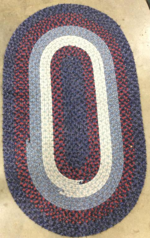 Multi Toned Oval Shaped Braided Rug: Rug is braided and wool. Contains tones of light blue red, white, & blue. Area rug, wool rug, carpet, braided rug, carpet. home accent, home accessory, decorative accessory Piece measures approx 56 in