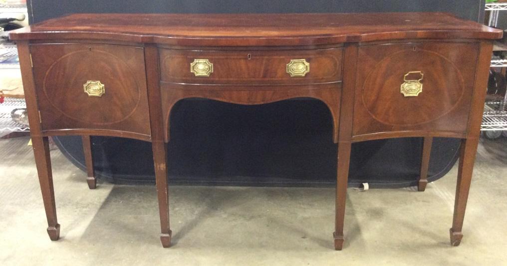 Vintage Carved Wooden Buffet Table: Buffet table has chocolate tone. Sheratan style frame, mahogany buffet, server, sideboard, dining room. Piece contains 1 Cabinet door, 1 drawer in center and 1 large drawer. All handles are gold toned