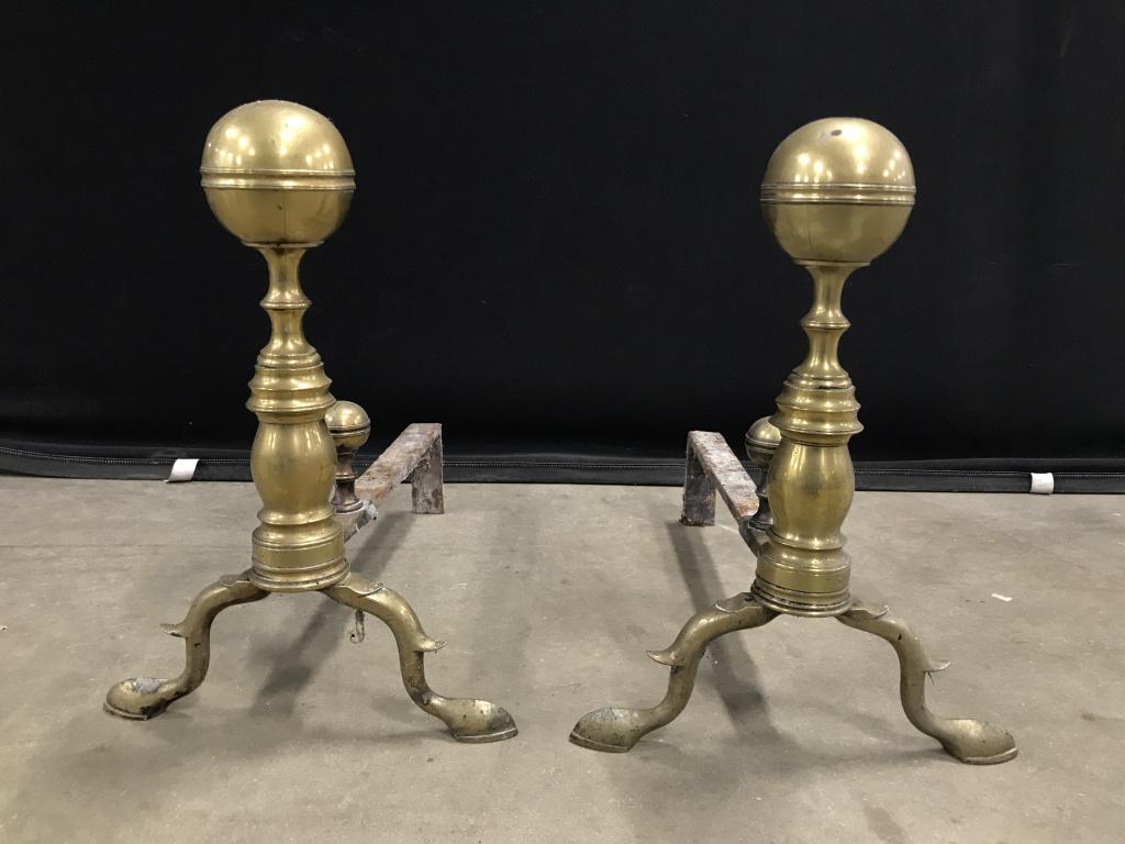 Pair Brass Toned Metal Hoof Footed Andirons: Pair Vintage Possibly Antique Brass Toned Metal Hoof Footed Andirons, dents, pitting and discoloration to areas of brass, measures approximately 16 inches tall x 12 inches wide x 18 inches deep. Firep