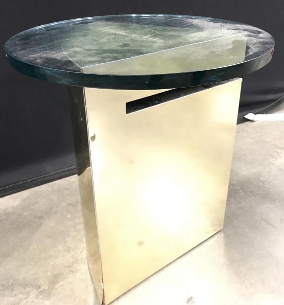 Circa 1970s brass glass geometric side table: Base Of table is gold toned. Table top is glass and round. Piece measures approx 20 inches tall 18 inches wide. Base has wear and may need minor repair in some areas. end table, home furnishings, lamp