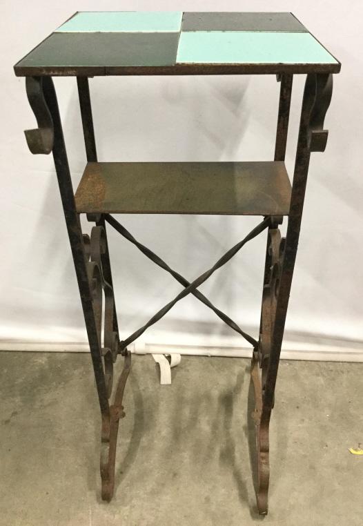 Vintage Tiled Top Metal Plant Stand: Plant stand is metal. Contains green and teal tile detail at top. Piece measures approx 31 inches tall 12 inches wide and deep. Plant stand, vintage plant stand, metal plant stand. Piece has some wear