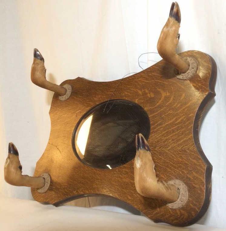 Oak Frame Beveled Mirror W Taxidermy Hooves: Mirror frame is oak. Contains 4 taxidermy deer hooves, feet, paws, Mirror is beveled. Piece appears to be vintage. Hooves as hooks becomes hat rack mirror, coat rack mirror, Taxidermy mirror, cabin de