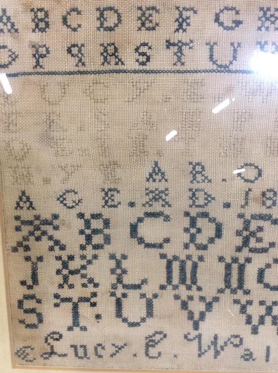 Antique needlepoint alphabet sampler c. 1829: Antique Signed Lucy Wales needlepoint alphabet sampler. Piece is dated 1829. Wooden rams. Measures approximately 13 by 11 inches. Artwork has not been inspected outside of frame. Wire in back for hang