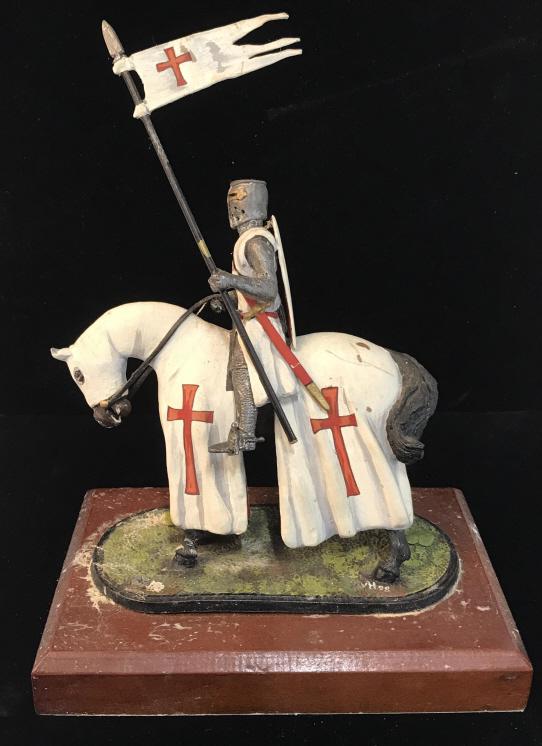 Crusader Knight Display Figural, England: Crusader Knight in Full Shield and Sword Armor, On Horse, Collectible Figural. Pewter metal knight & horse. Horse, flag and armor painted white with red crusader cross. Discoloration on wood plaque, m