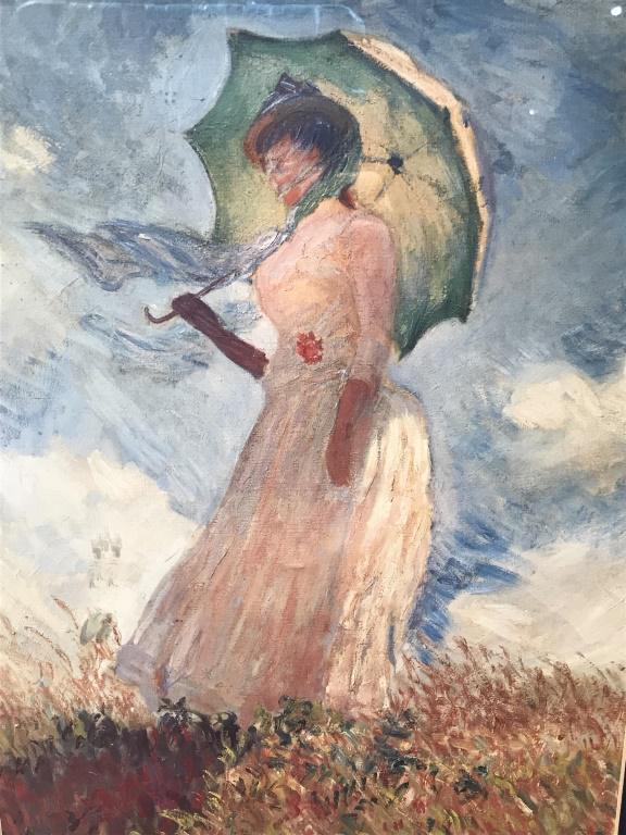 Monet Print Of Woman In Frame: Monet Print Of Woman, double matted and set behind acrylic in gold tone wood style frame. Measures approximately 21.5 inches in height by 17.5 inches in width with frame, minor blemish in frame and ma