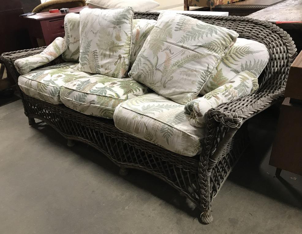 Outdoor Woven Wicker Sofa W Cushions: Sofa is Woven Wicker. Wicker is slate toned. Piece includes cushions & Pillows with leaf & vine detail. Sofa is footed. Outdoor sofa, wicker sofa. hoe furnishings and accent, garden patio furniture Me