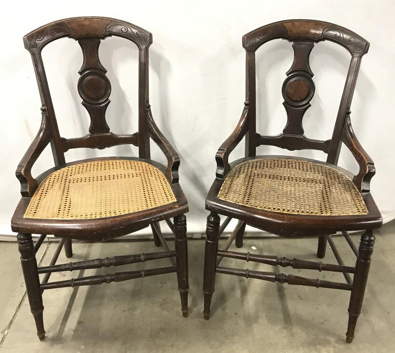 Pair Antique Carved Wooden Side Chairs: Pair Antique Carved Wooden Side Chairs With caned seats and turned legs and rungs, some chips and scratches due to age and use, measures approximately 35 inches tall x 19.5 inches wide x 22 inches dee
