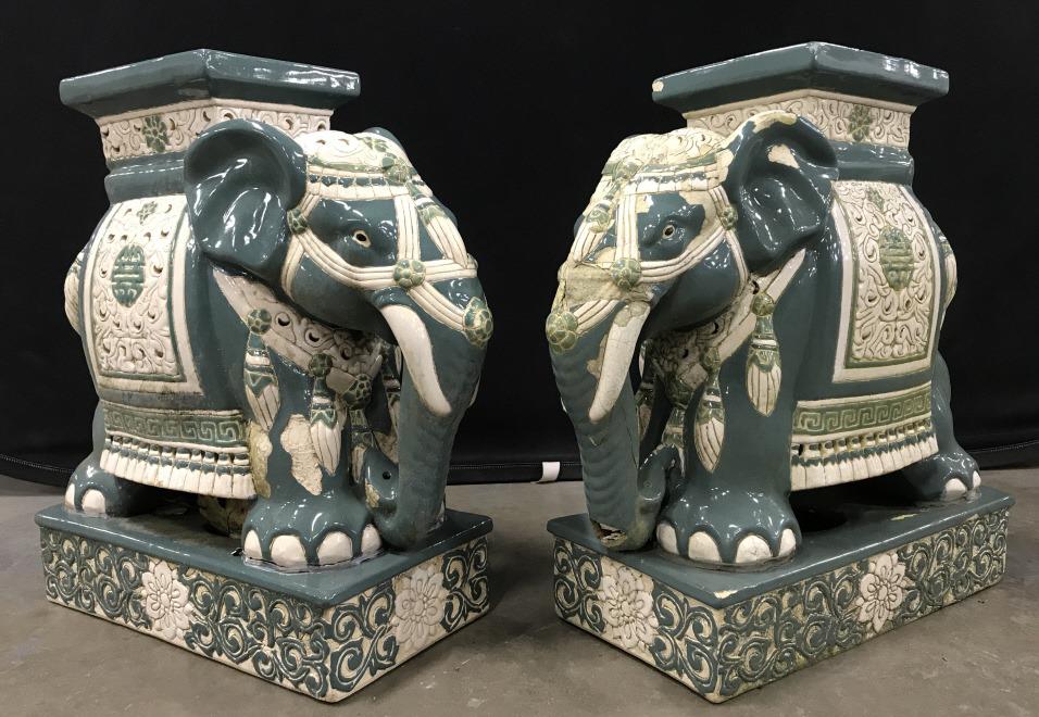 Pair Glazed Ceramic Elephant Plant Stands: Pair Oriental Style Ceramic Elephant Plant Stands in cream and green toned glazed finish, chips to surface throughout both pieces, repair to one base, measures approximately 20 inches long x 8 inches 