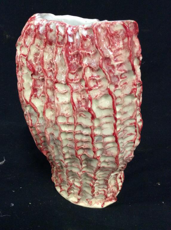 Jb MMIX Signed Ceramic ruffled vase: Ruffle texture vase with red glaze. Ceramic vase is signed jb mmix on bottom. Irregularly Shaped And measures approximately 11 inches tall.appears to be handcrafted. Vase, ceramic vase, decorative art