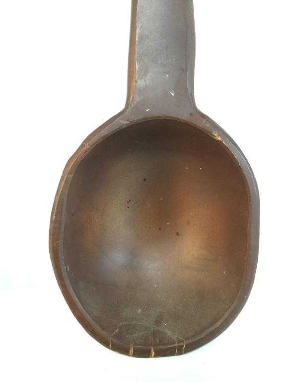 Brown Toned Grand Decorative Wooden Spoon: Spoon is wooden. Piece is brown toned. Piece has hanging wire. Measures approx 28 inches long 5 inches wide. serving spoon, flatware, kitchen utensil 6