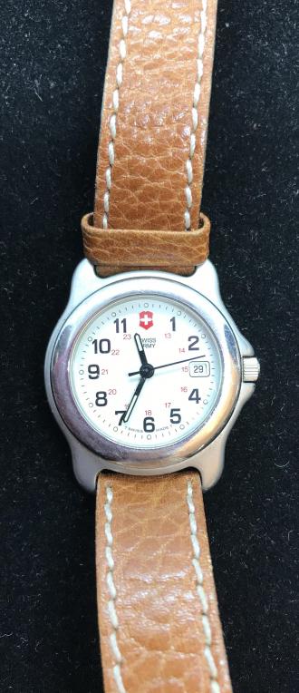 Swiss Army Leather Band Wristwatch: Comes in a box marked Anne Klein II. Stainless steel backing, water resistant, medium brown leather. Swiss Army written on Band latch. Extends 7 3/4 in. length. Has large numbers and seconds hand. Wat