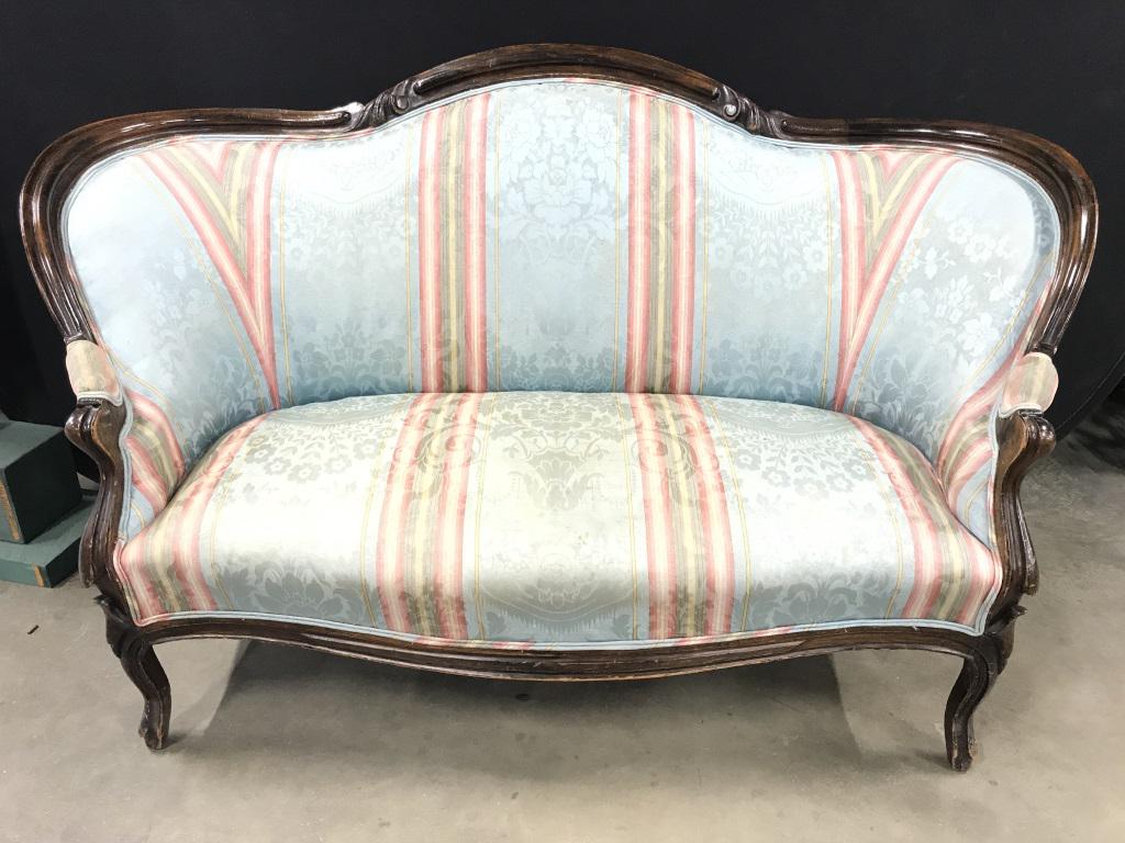 Vintage Carved Wood Frame Sette Loveseat: Frame of loveseat has carved wooden detail. Piece is upholstered with multi toned floral leaf & stripe detail. Piece measures approx. 57 inches long 34 inches tall 29 inches deep. Contains some discol